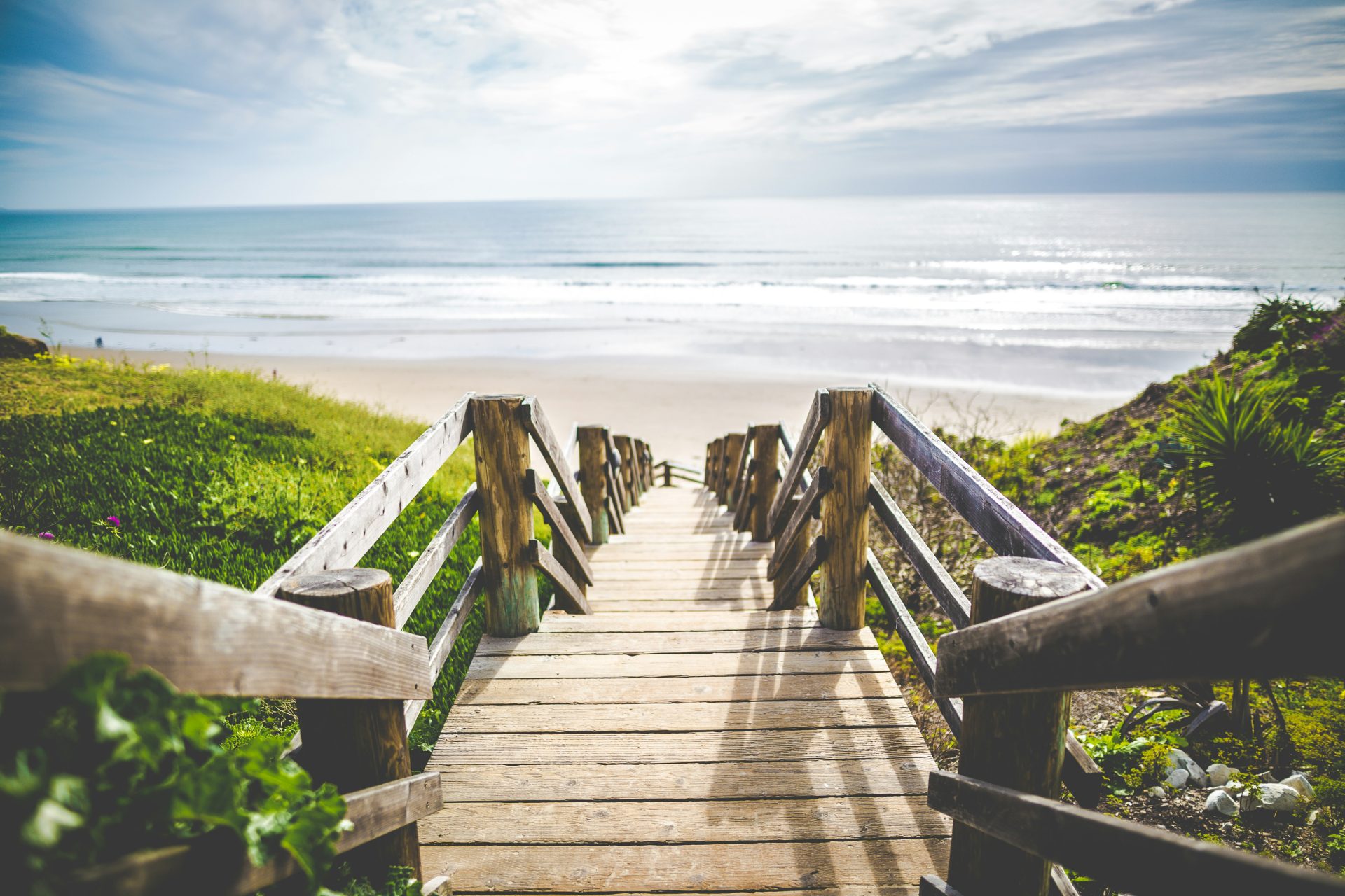 Escaleras de madera que bajan a una playa
